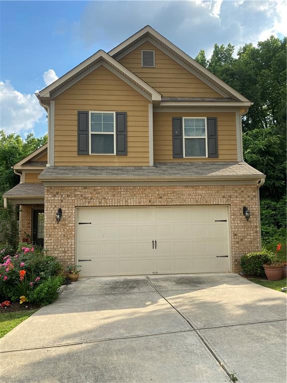 a front view of a house with a yard and garage