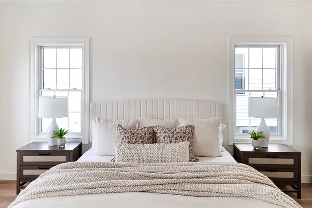 a bedroom with a large bed and a window