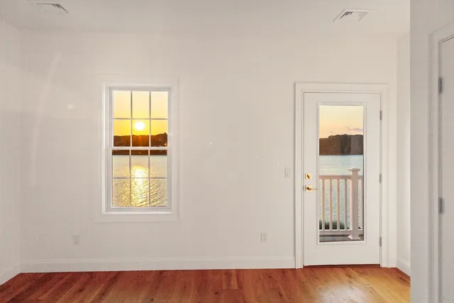 an empty room with windows and closet