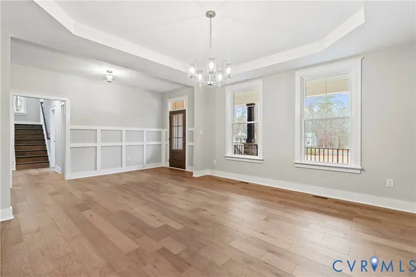 a kitchen with refrigerator a stove and chairs