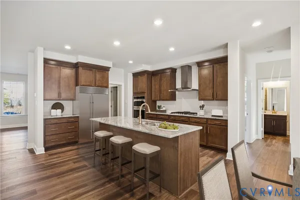 a large kitchen with a table and chairs