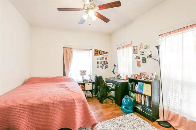 a bed room with a bed window and book shelf