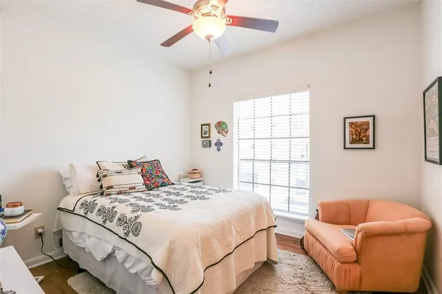a bedroom with bed couch and window