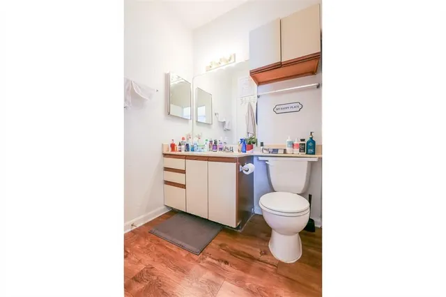 a bathroom with a sink toilet and a mirror