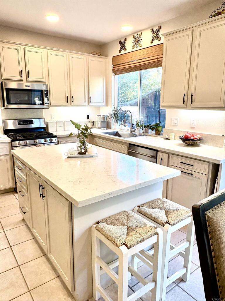 2879 Bear Valley Road Chula Vista, CA 91915 - Photo 15 of 61 a kitchen with a stove a sink and a refrigerator