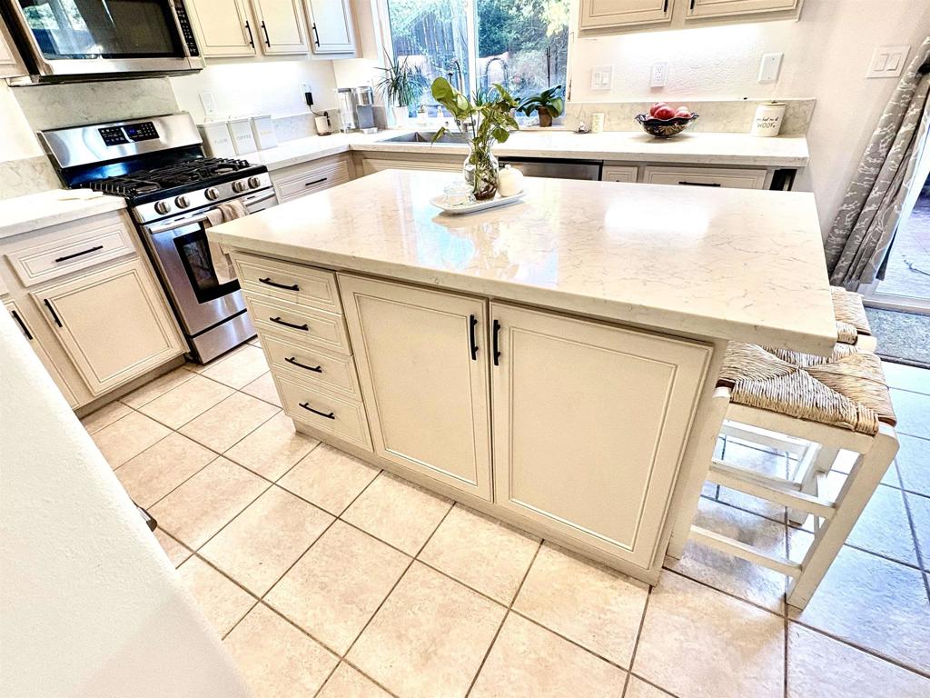 2879 Bear Valley Road Chula Vista, CA 91915 - Photo 16 of 61 a kitchen with a sink a stove cabinets and counter space