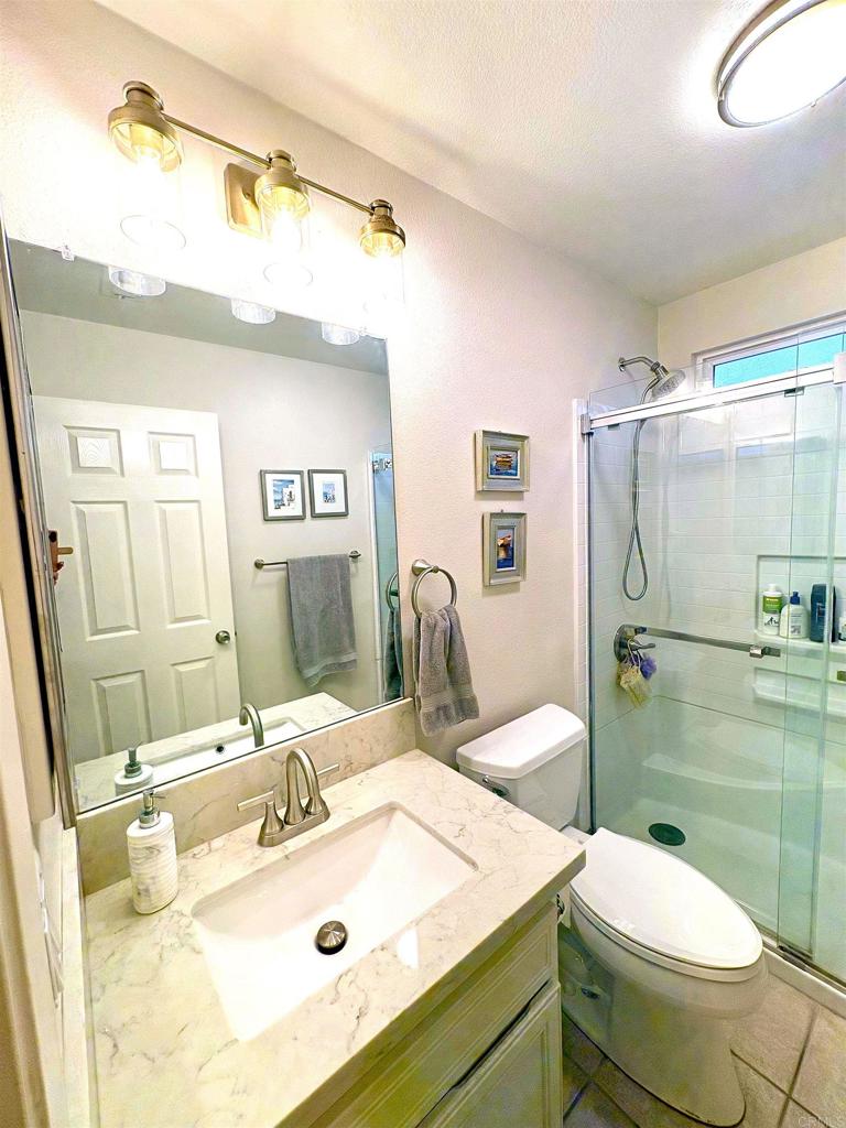 2879 Bear Valley Road Chula Vista, CA 91915 - Photo 30 of 61 a bathroom with a sink toilet and shower