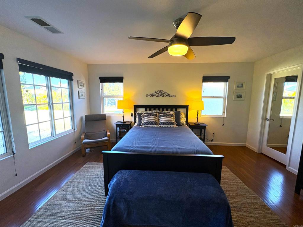 2879 Bear Valley Road Chula Vista, CA 91915 - Photo 39 of 61 a bedroom with a bed and wooden floor