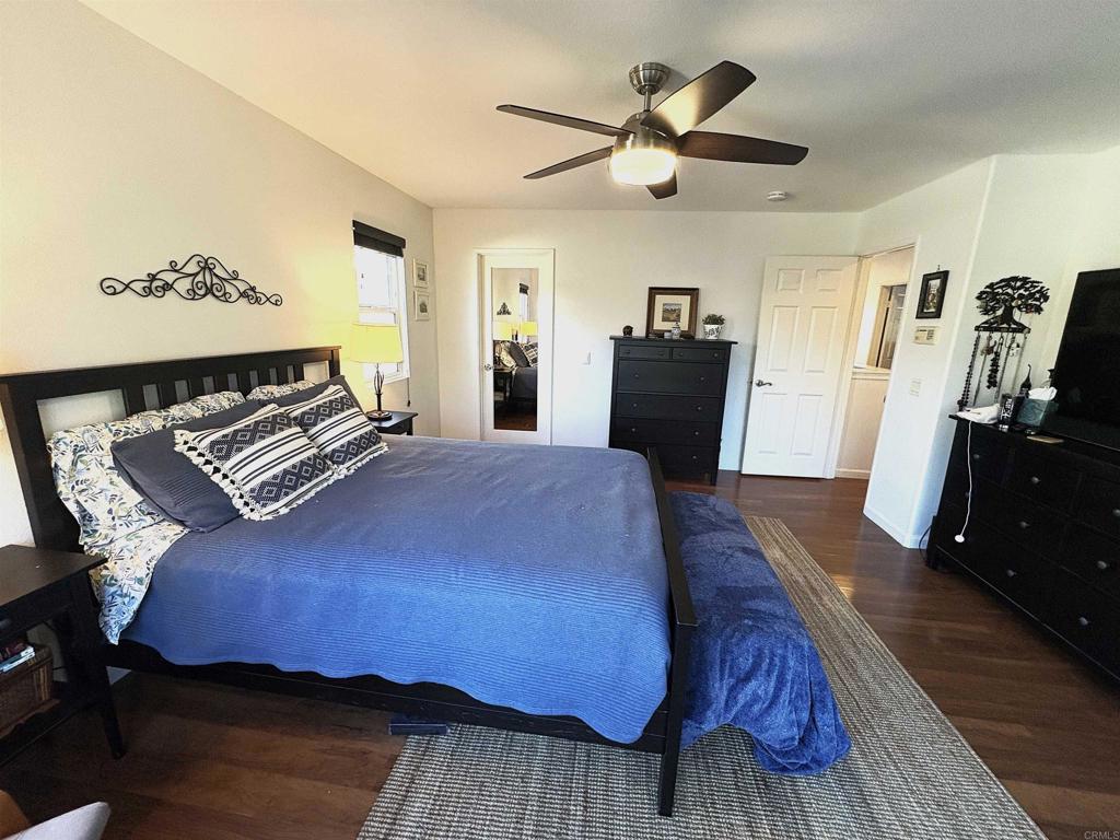 2879 Bear Valley Road Chula Vista, CA 91915 - Photo 44 of 61 a bedroom with a bed and wooden floor