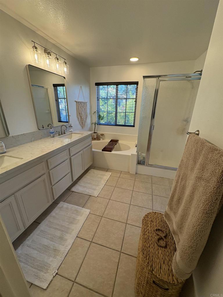 2879 Bear Valley Road Chula Vista, CA 91915 - Photo 48 of 61 a bathroom with a tub sink and mirror