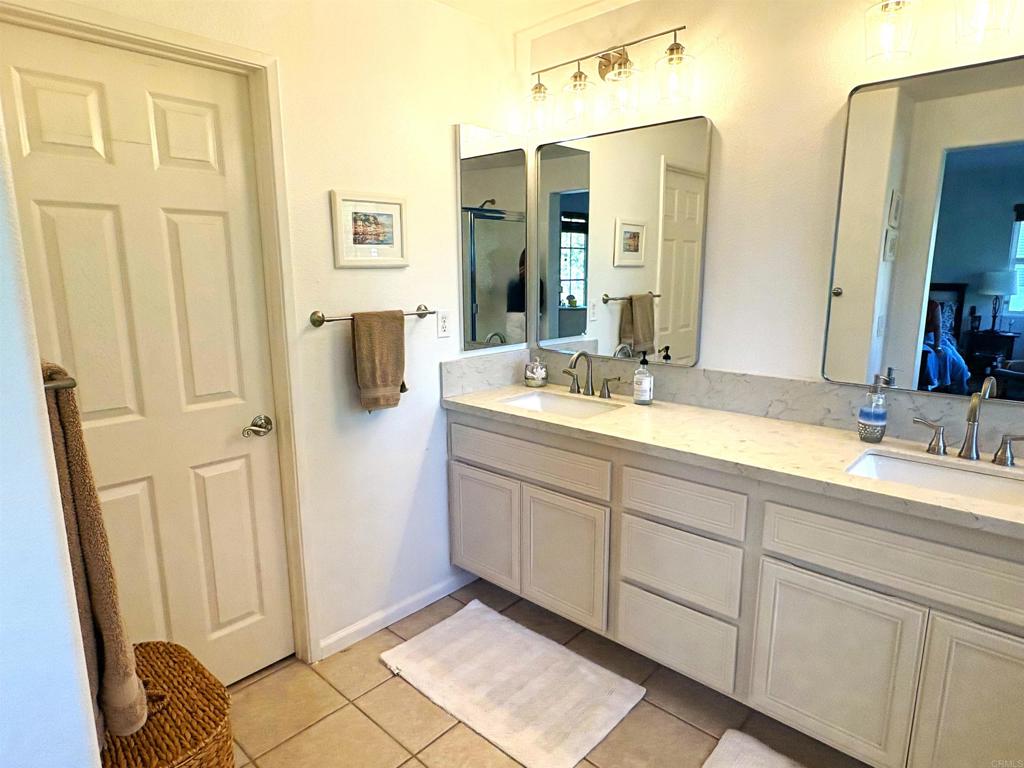 2879 Bear Valley Road Chula Vista, CA 91915 - Photo 49 of 61 a spacious bathroom with double vanity and a mirror