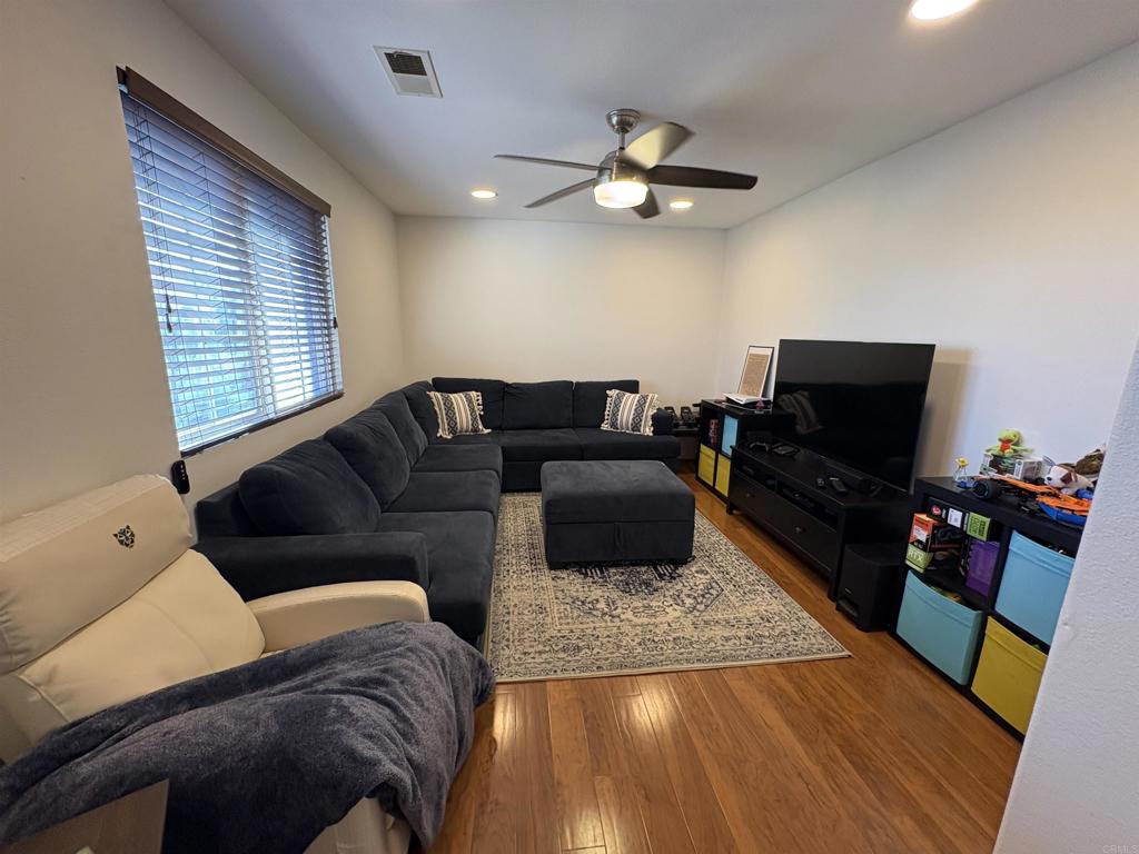 2879 Bear Valley Road Chula Vista, CA 91915 - Photo 50 of 61 a living room with furniture and a flat screen tv