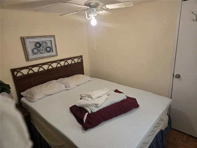 a bedroom with a bed and a chandelier