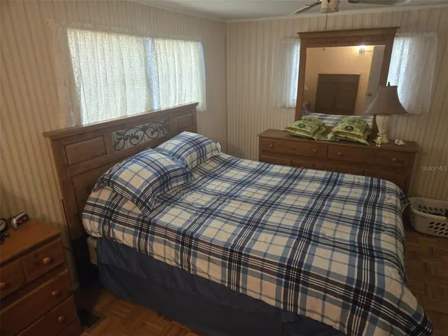 a bedroom with a bed and a mirror