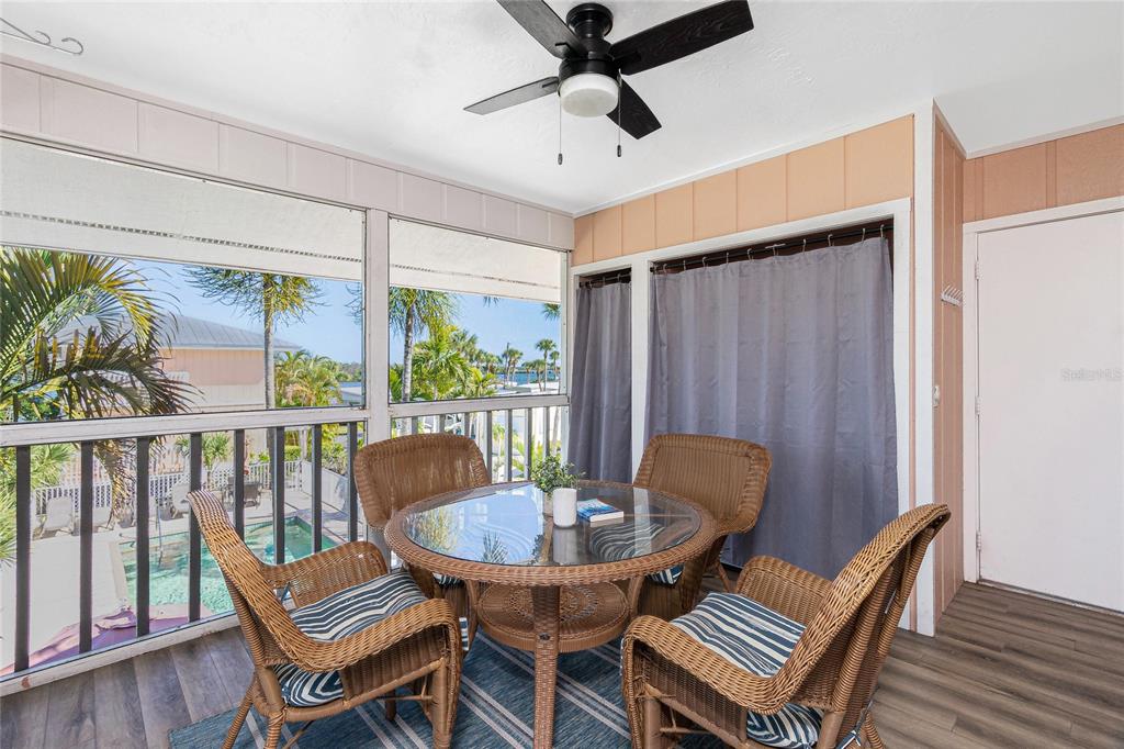 2375 North Beach Road, Unit 2B Englewood, FL 34223 - Photo 18 of 44 a view of a dining room with furniture window and wooden floor