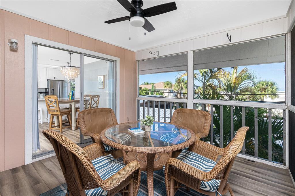 2375 North Beach Road, Unit 2B Englewood, FL 34223 - Photo 20 of 44 a dining room with furniture a rug and a floor to ceiling window