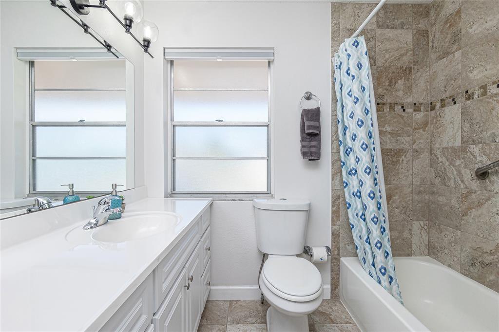 2375 North Beach Road, Unit 2B Englewood, FL 34223 - Photo 24 of 44 a bathroom with a sink toilet and shower