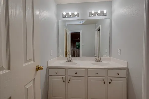 a bathroom with a sink double vanity and a mirror