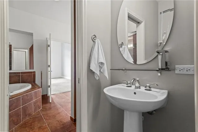 a bathroom with a sink a toilet and a mirror