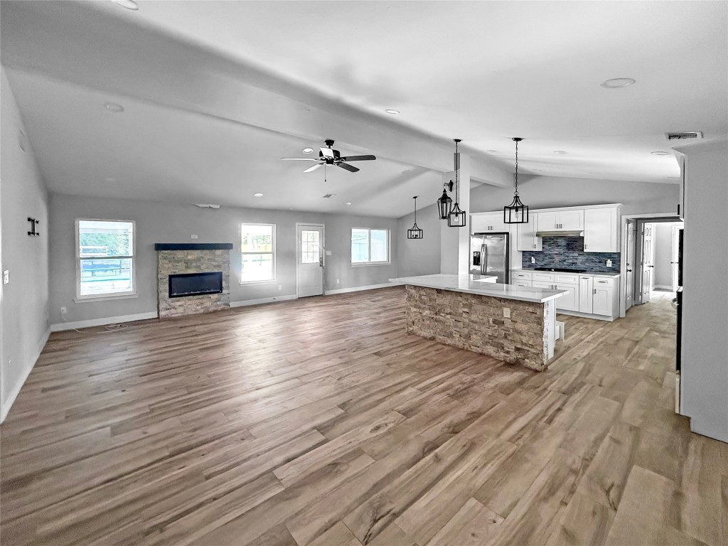 3706 Roberts Boulevard Baytown, TX 77521 - Photo 11 of 22 an empty room with wooden floor and fireplace