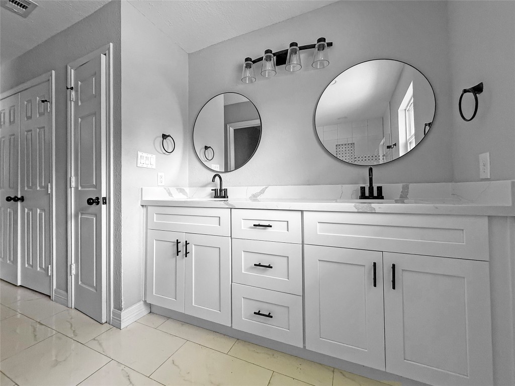 3706 Roberts Boulevard Baytown, TX 77521 - Photo 15 of 22 a bathroom with double vanity sink and a mirror