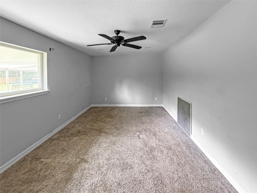 3706 Roberts Boulevard Baytown, TX 77521 - Photo 16 of 22 an empty room with a window and a fan
