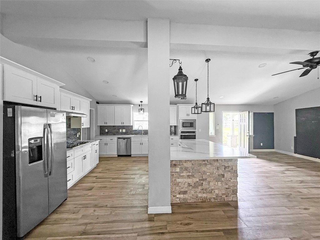3706 Roberts Boulevard Baytown, TX 77521 - Photo 6 of 22 a large kitchen with stainless steel appliances kitchen island granite countertop a refrigerator and a sink