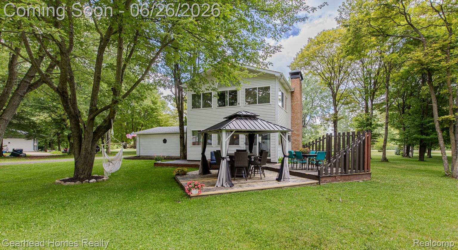12364 Morrish Road Clio, MI 48420 - Photo 71 of 81 Expansive green lawn surrounds a white two-story residence with a prominent red brick chimney