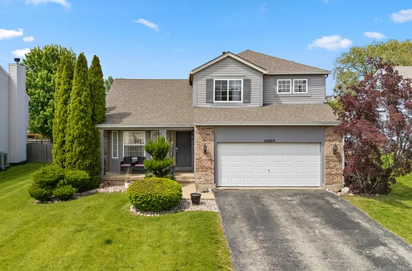 a front view of a house with a yard and garage
