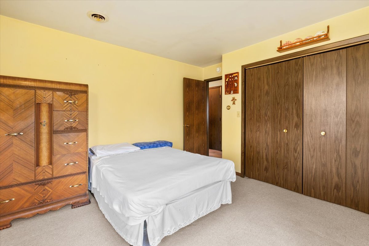 7112 Altenburg Road Harvard, IL 60033 - Photo 11 of 26 a bedroom with a bed and cabinets