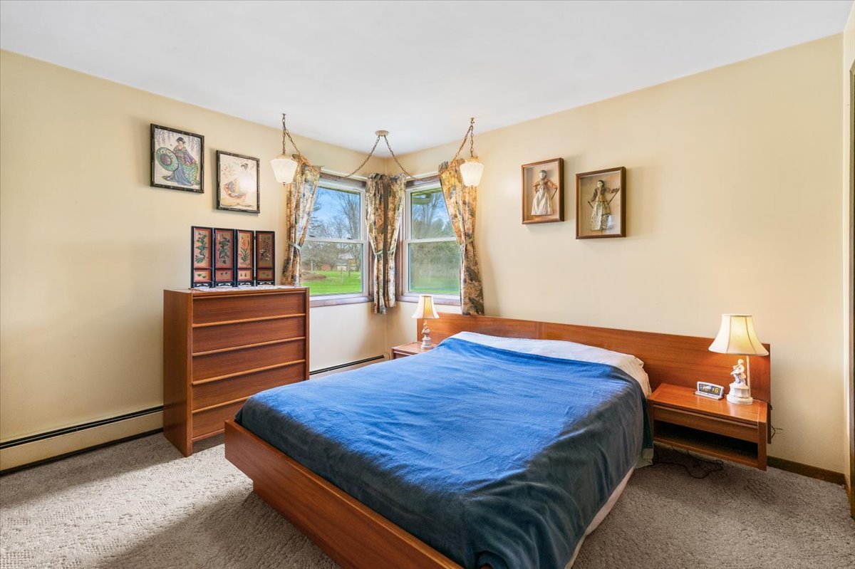 7112 Altenburg Road Harvard, IL 60033 - Photo 14 of 26 a bedroom with a bed and wooden floor