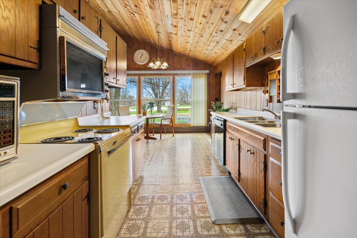 7112 Altenburg Road Harvard, IL 60033 - Photo 5 of 26 a kitchen with stainless steel appliances granite countertop a stove and a sink