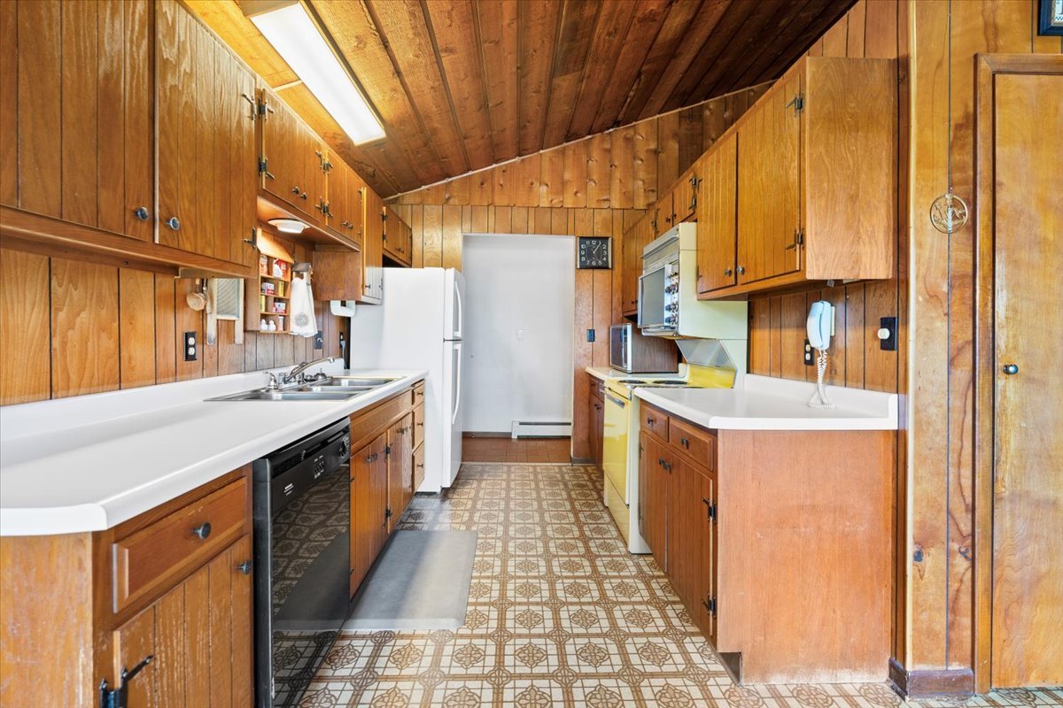 7112 Altenburg Road Harvard, IL 60033 - Photo 6 of 26 a kitchen with stainless steel appliances granite countertop a stove a sink and dishwasher with cabinets