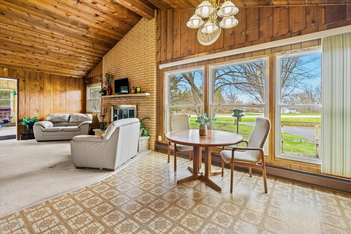 7112 Altenburg Road Harvard, IL 60033 - Photo 7 of 26 a living room with furniture and a large window