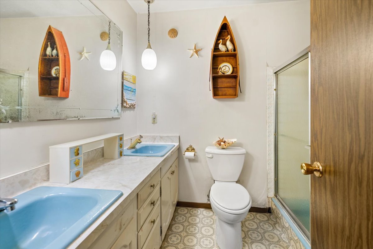 7112 Altenburg Road Harvard, IL 60033 - Photo 10 of 26 a bathroom with a granite countertop toilet sink and mirror
