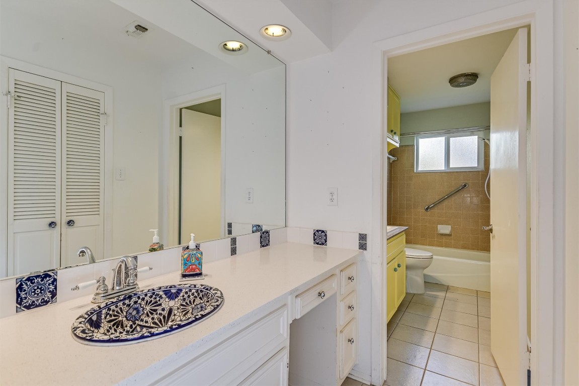 8151 Meandering Way Austin, TX 78759 - Photo 12 of 23 a bathroom with a granite countertop sink and a mirror