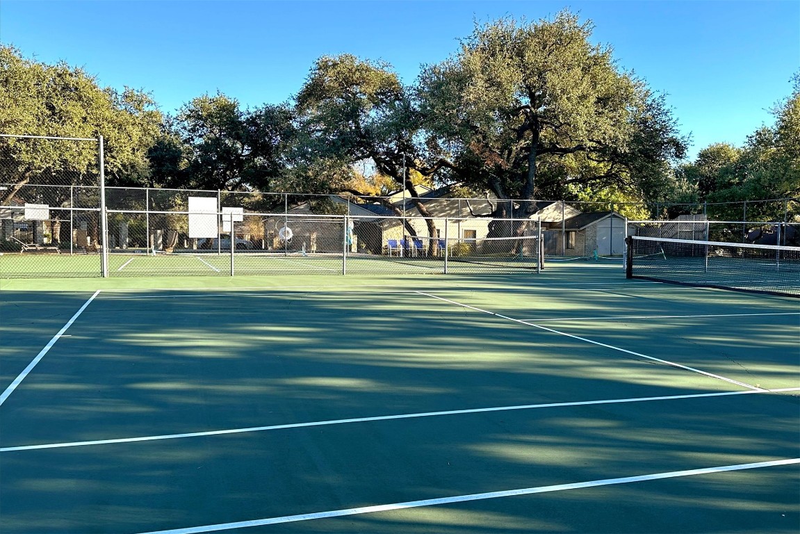 8151 Meandering Way Austin, TX 78759 - Photo 22 of 23 a view of a tennis ground with a large trees