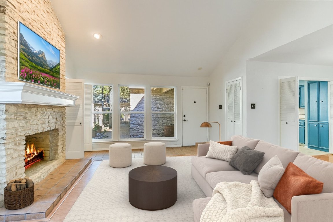 8151 Meandering Way Austin, TX 78759 - Photo 5 of 23 a living room with furniture a fireplace and a large window