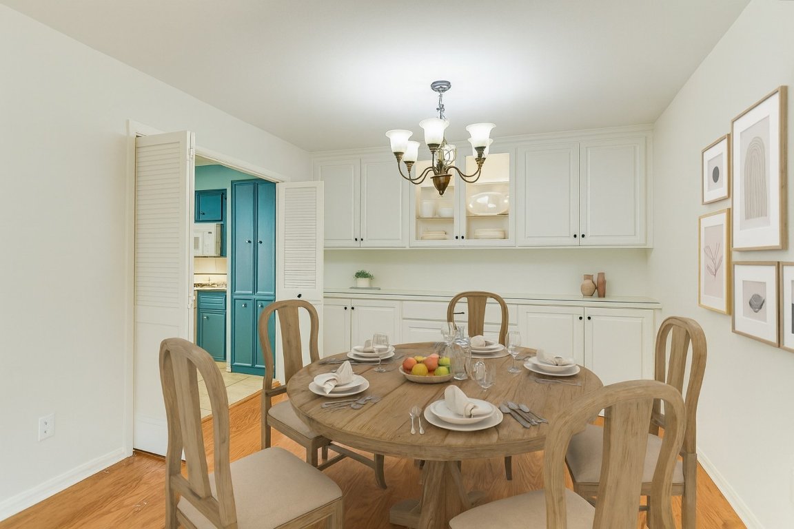 8151 Meandering Way Austin, TX 78759 - Photo 8 of 23 a view of a dining room with furniture a chandelier and wooden floor