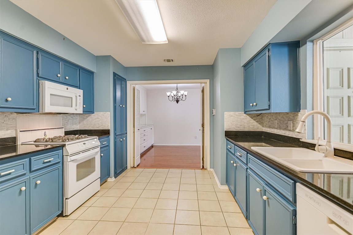 8151 Meandering Way Austin, TX 78759 - Photo 10 of 23 a kitchen with a sink stove and cabinets