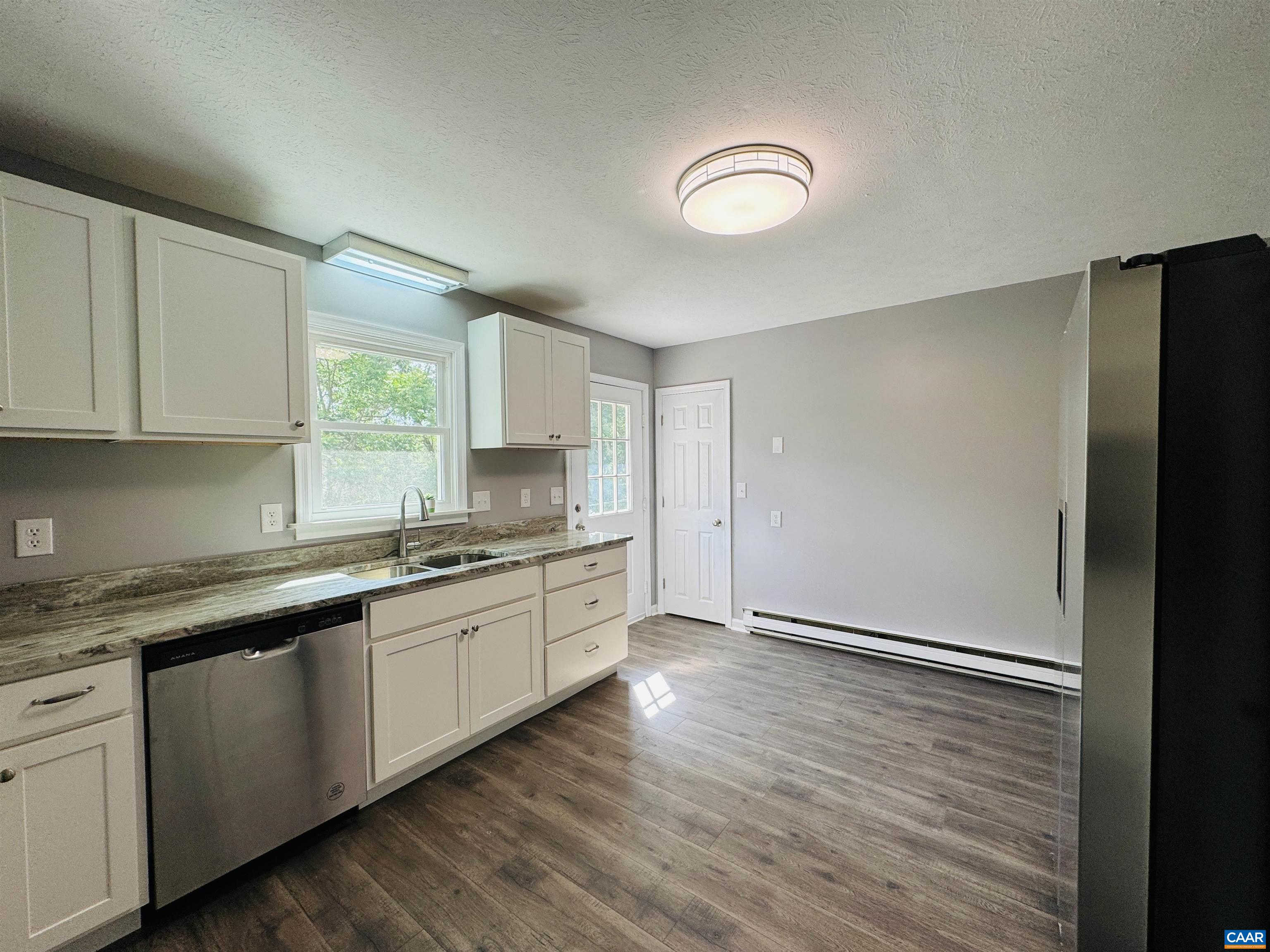 5000 White Bridge Road Waynesboro, VA 22980 - Photo 26 of 74 a kitchen with granite countertop white cabinets and wooden floor
