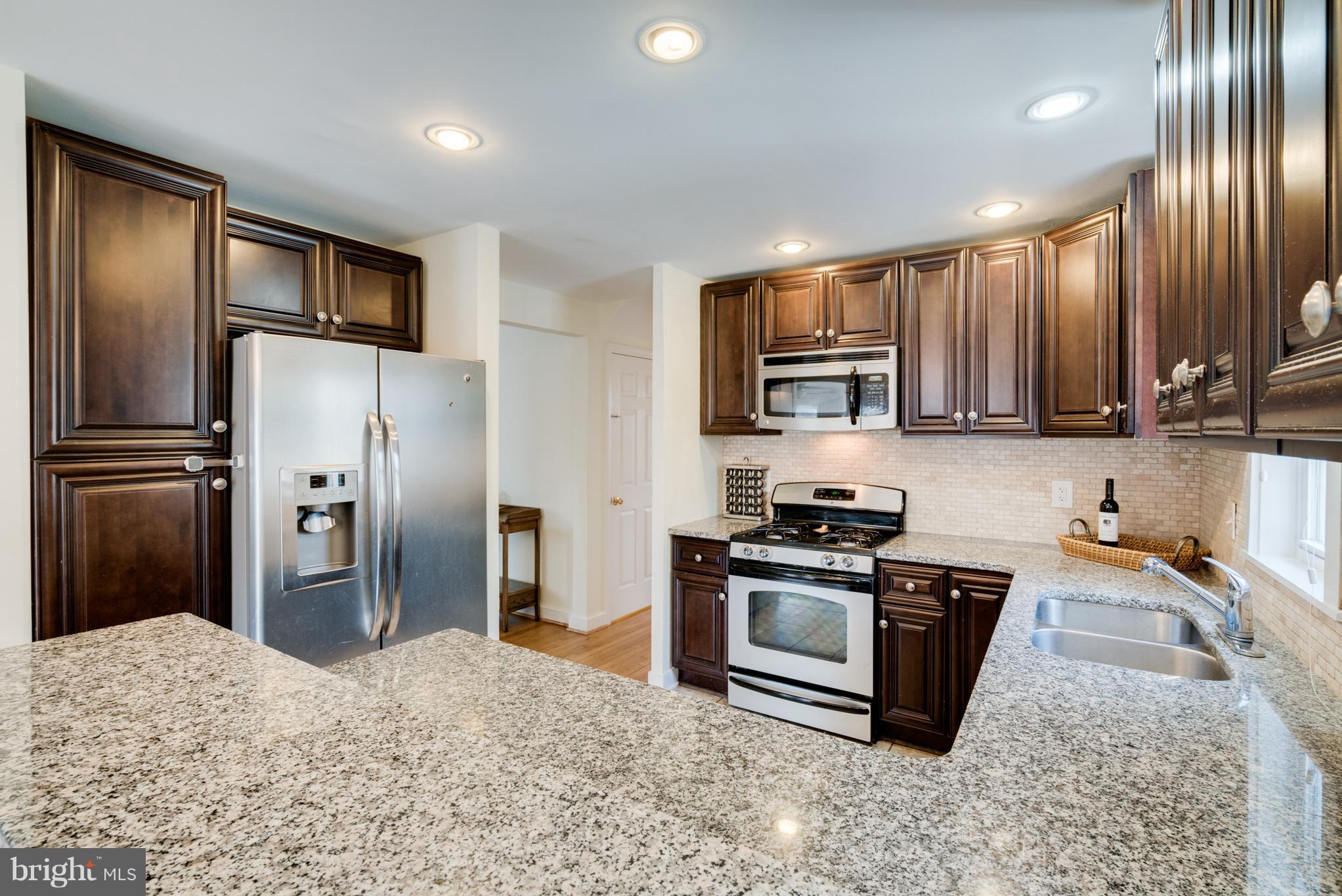 10303 Ridgemoor Drive Silver Spring, MD 20901 - Photo 8 of 29 a kitchen with stainless steel appliances granite countertop a refrigerator stove and oven