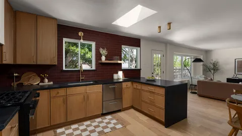 a kitchen with granite countertop a sink stove and cabinets
