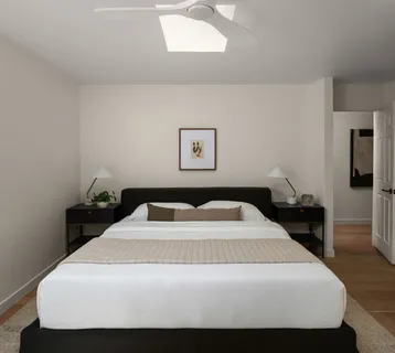 a bedroom with a bed and a lamp