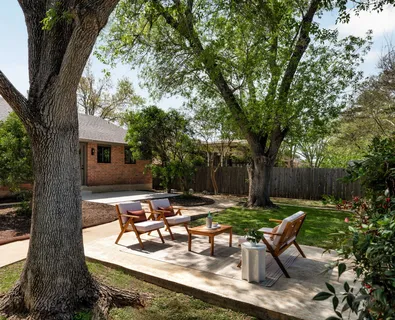 a view of a backyard with sitting area