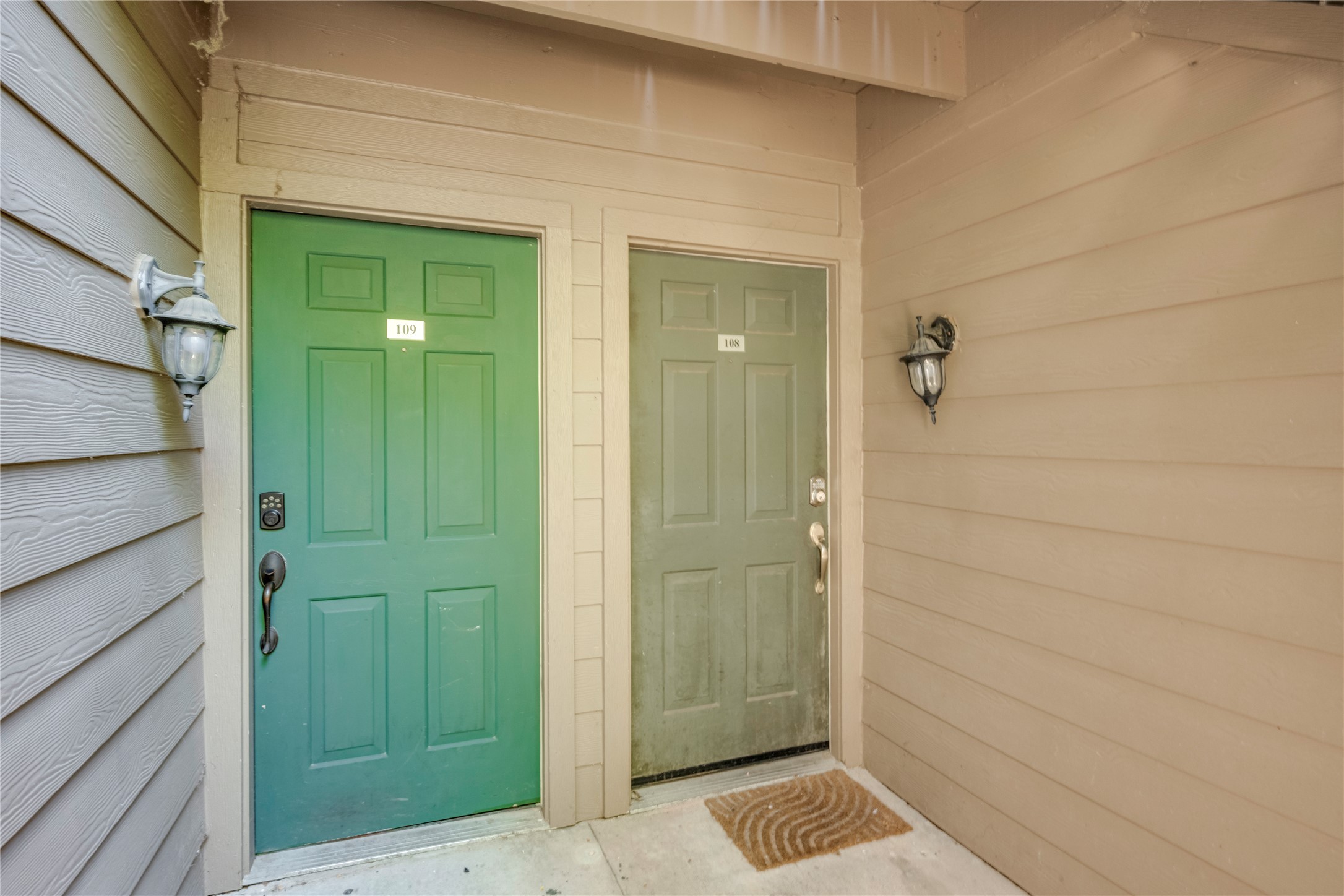 3627 Menchaca Road, Unit 108 Austin, TX 78704 - Photo 19 of 24 Welcoming covered entryways feature wood siding and classic coach lighting fixture accents.