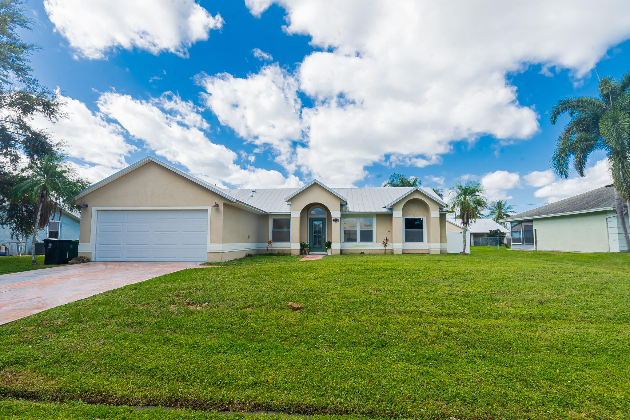 526 Southwest Dairy Road Port St. Lucie, FL 34953 - Photo 1 of 23 a view of a yard in front of a house with large trees