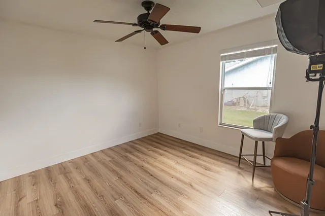 a view of room with window and wooden floor