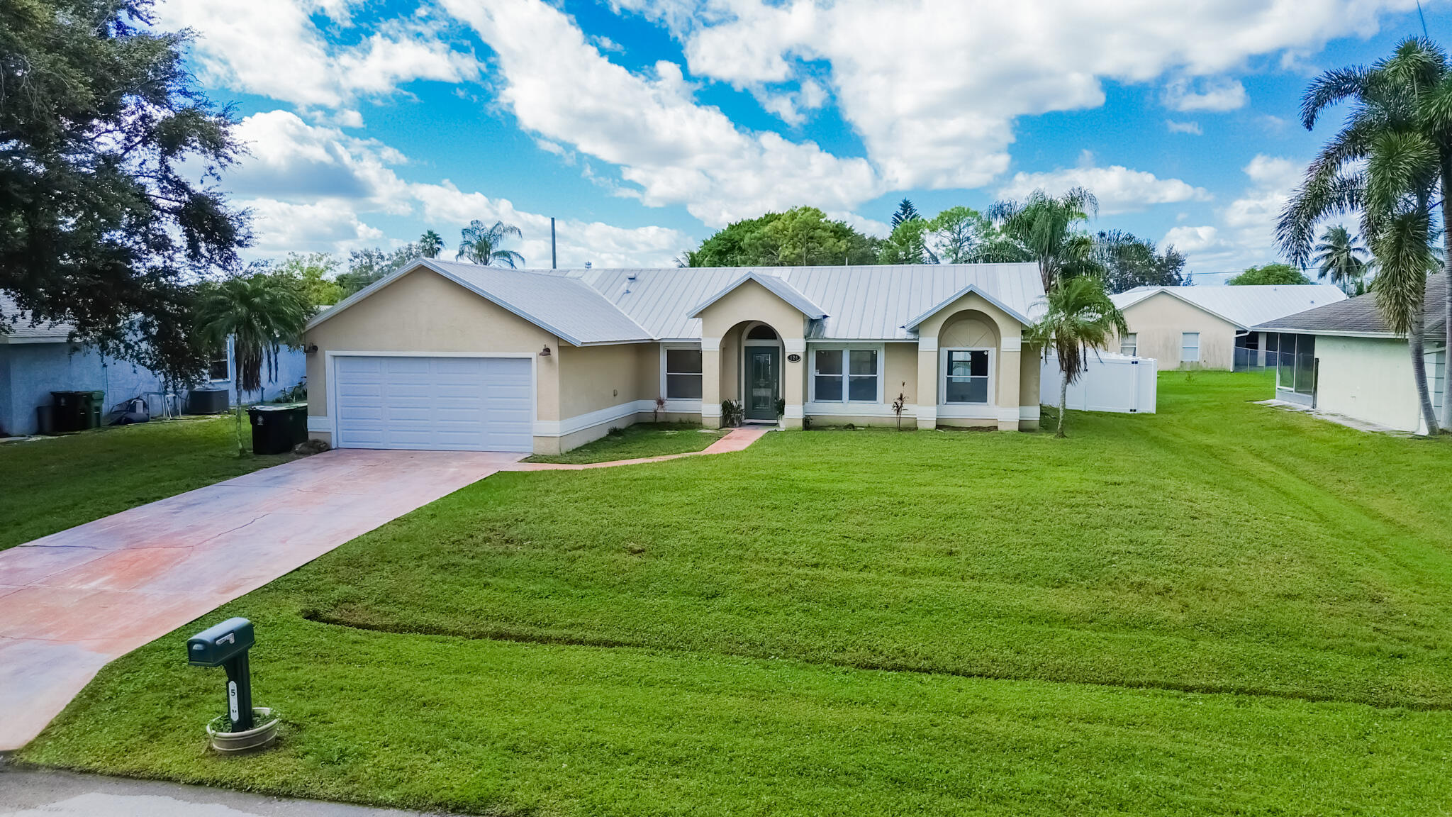 526 Southwest Dairy Road Port St. Lucie, FL 34953 - Photo 17 of 23 a front view of a house with a yard