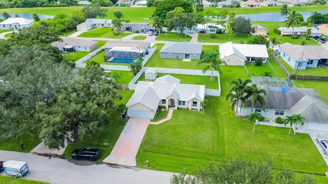an aerial view of multiple houses with yard